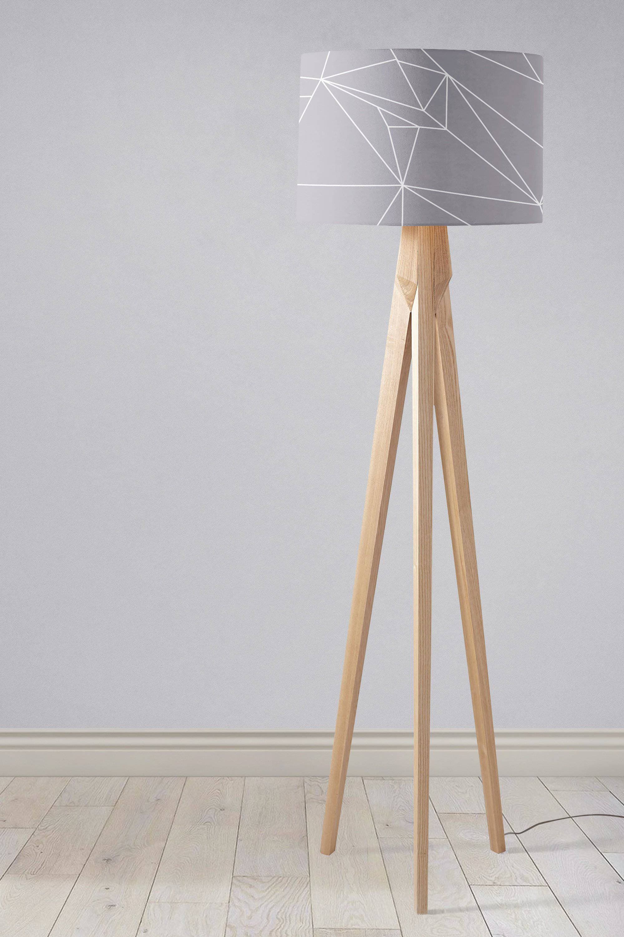 Modern tripod floor lamp with gray fabric lamp shade featuring white geometric lines and light wood legs inch diameter