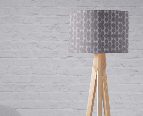 Grey table lamp with white squares geometric lampshade and light wood tripod base in inch diameter design