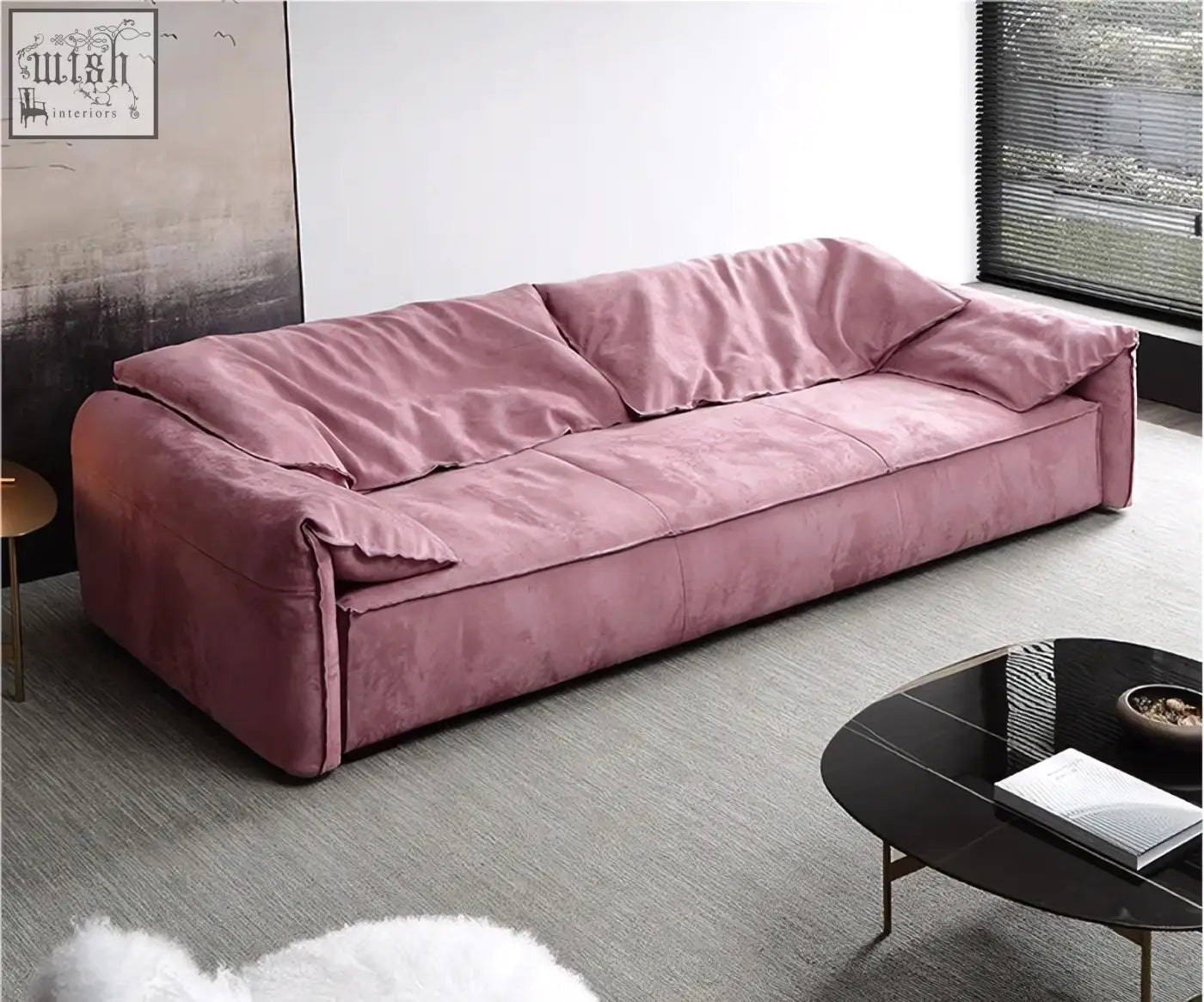 A dusty rose velvet grimm three seater sofa with a modern low-profile design and integrated cushions