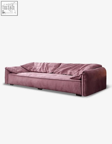 A grimm velvet sofa in dusty rose with plush velvet and a modern low-profile design that seamlessly blends style
