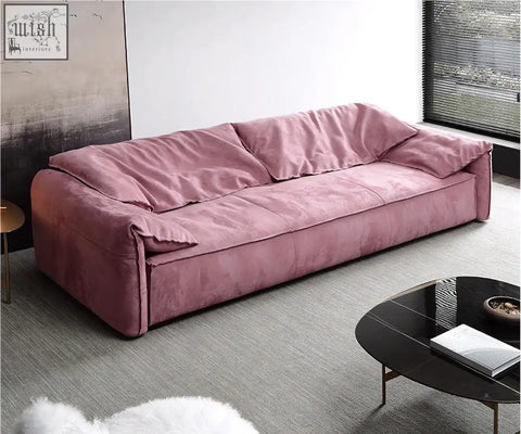 A grimm velvet sofa in dusty rose with a modern low-profile design that seamlessly blends style and comfort