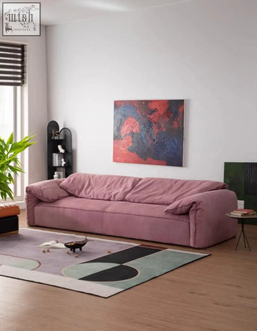 A plush dusty rose grimm velvet sofa with soft rounded cushions that seamlessly blends style and comfort