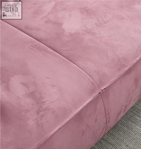 A dusty rose suede cushion with subtle texture and clean stitching on the grimm three seater sofa velvet