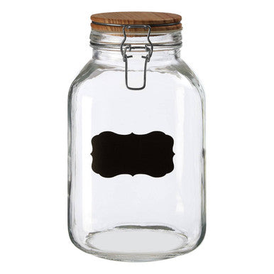 Clear glass storage jar with wooden lid and metal clasp featuring a black chalkboard style label front view