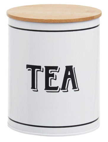 White metal tea canister grocer with a white cylindrical body natural wood lid and black trim for tea storage