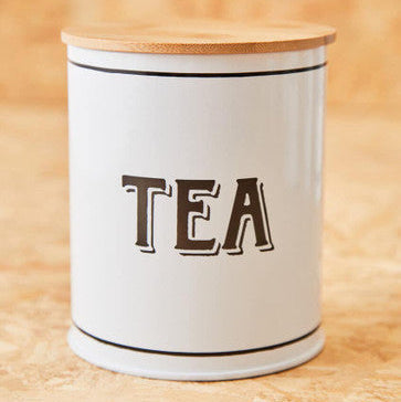 White metal tea canister with enamel finish natural wood lid and black trim perfect for kitchen storage