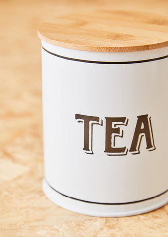 White metal tea canister with a natural bamboo lid and black lettering for stylish kitchen storage