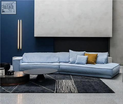 Grover three seater corner sofa in light blue suede with matching cushions and a mustard yellow accent pillow