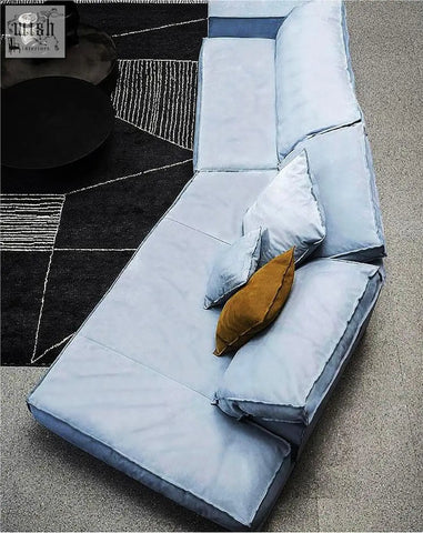 Light blue velvet grover three seater corner sofa with a mustard yellow throw pillow for cozy seating