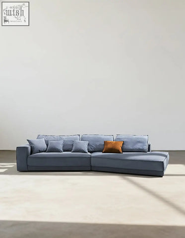 Modern gray suedue grover three seater corner sofa with single orange throw pillow for cozy seating