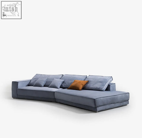 Modern gray suede grover three seater corner sofa with sleek minimalist design and warm orange accent pillow