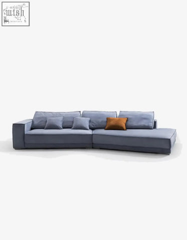 Modern gray grover three seater sofa in suedue with a sleek design and warm orange accent pillow perfect as a corner sofa