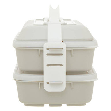 Beige two-tiered grub tub lunch box with warm grey white plastic latch and handle for easy carrying