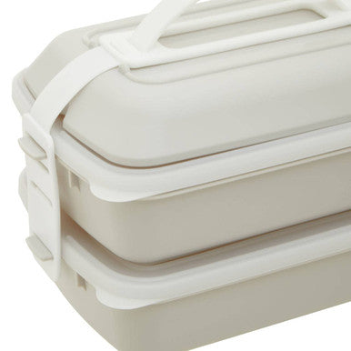 White plastic stackable grub tub lunch box with integrated handle and side latches in warm grey and white