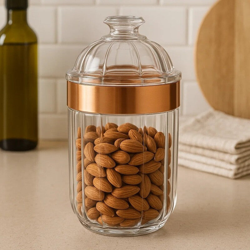Clear glass jar with medium rose gold acrylic band and fluted lid filled with almonds for storage