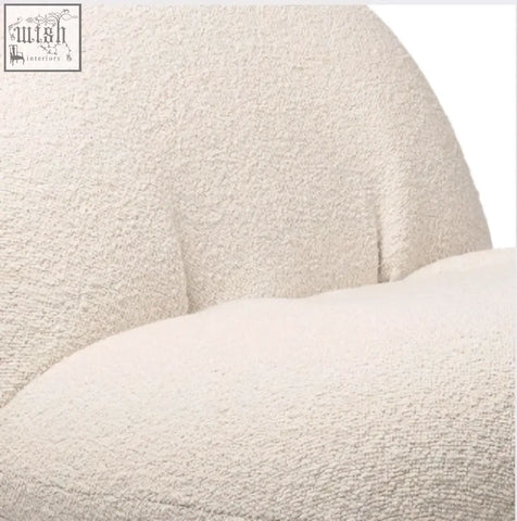 Cream-colored gubi pacha chair cushion with plush boucle fabric and soft cozy texture on gold base accent chair