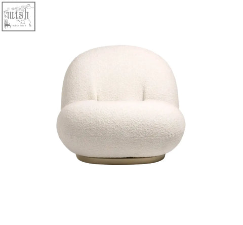 Cream-colored gubi pacha chair with plush boucle fabric and sleek gold metallic base perfect for accent seating