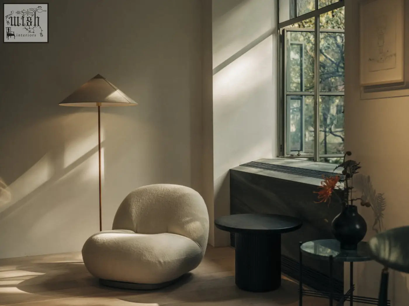 Cream-colored gubi pacha chair with plush boucle upholstery and gold base perfect as an accent chair