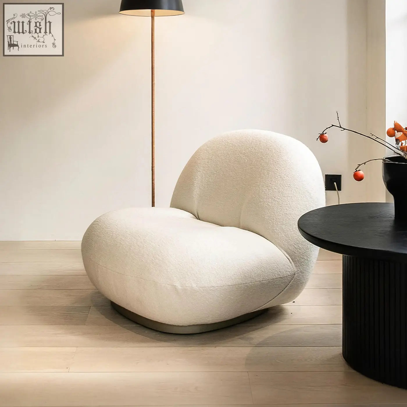Cream-colored gubi pacha accent chair with plush boucle fabric and sleek gold metal base for cozy seating