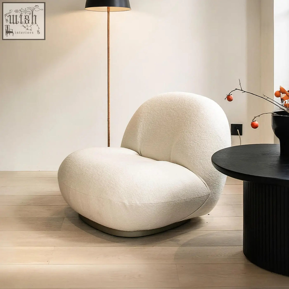 Cream-colored gubi pacha accent chair with plush boucle fabric and sleek gold metal base for cozy seating