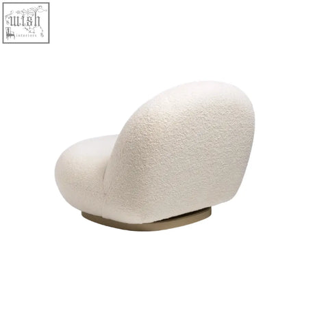 Cream-colored gubi pacha armchair with plush boucle upholstery and sleek gold metal base perfect as an accent chair