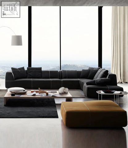 Black leather guzman velvet corner sofa with contrasting stitching and multiple throw pillows for cozy seating