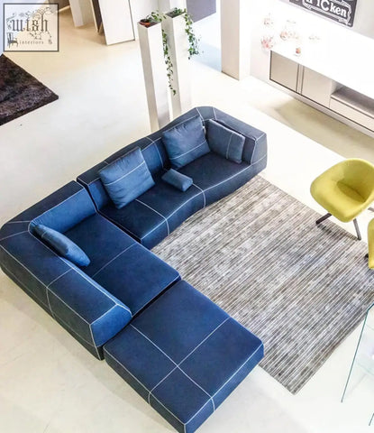 Deep blue guzman velvet corner sofa with clean geometric lines and white stitching in a modular velvet corner sofa design