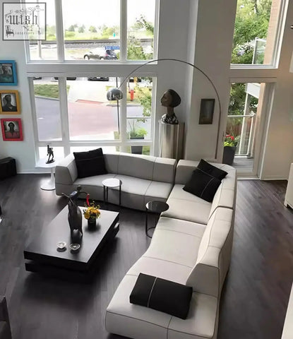 Modern off-white guzman velvet corner sofa with black accent pillows featuring a sleek minimalist design