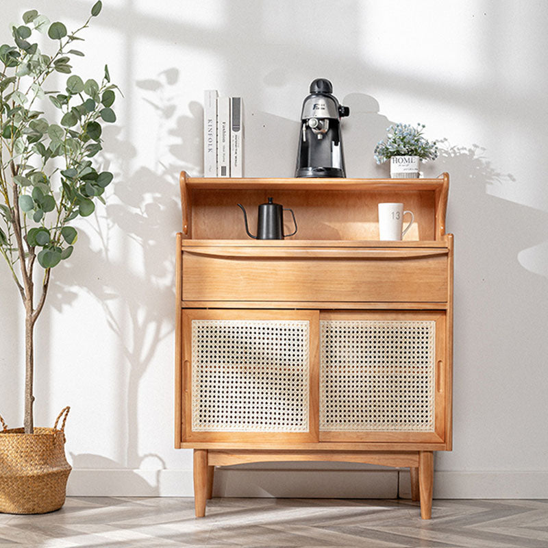 Light wood h11 elvis rattan sideboard with cane panel doors and top shelf with books coffee maker and plants oak finish