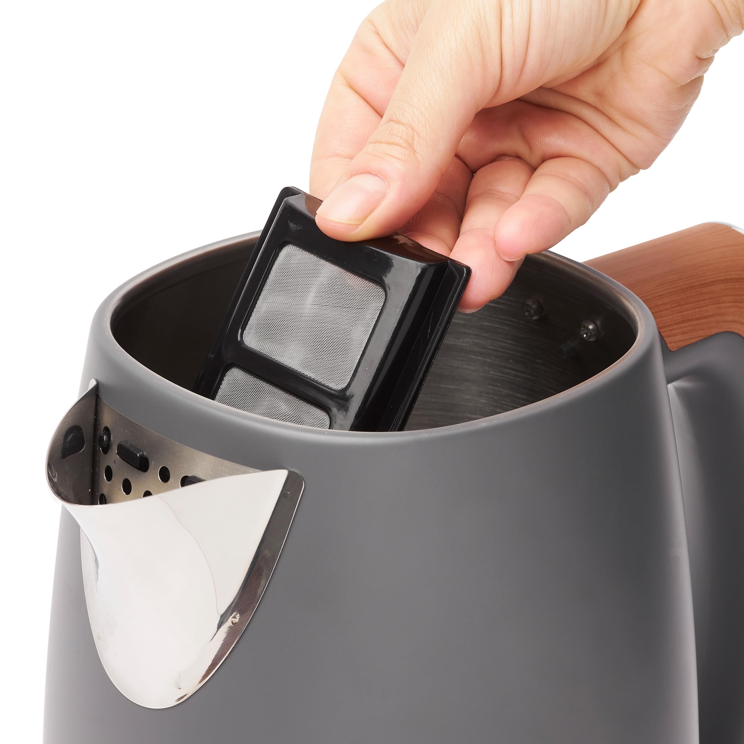 Black plastic mesh filter being placed into the haden dorchester temperature control kettle for easy cleaning