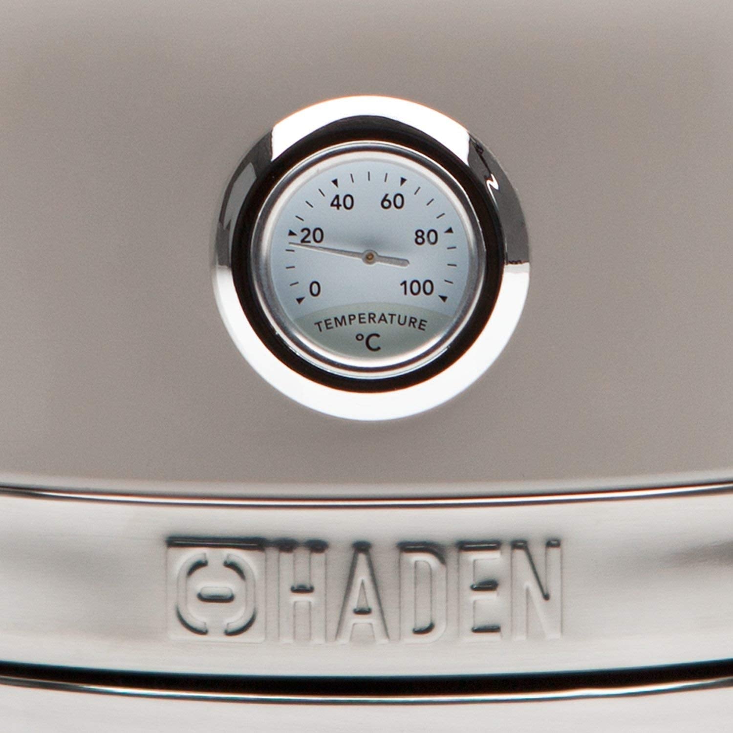 A sleek silver haden stainless steel thermometer with a circular dial highlighting safety features and rapid boil technology