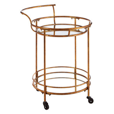 Hadley 2 tier gold finish drinks trolley with gold finish metal frame, circular glass top, lower shelf, and black caster wheels