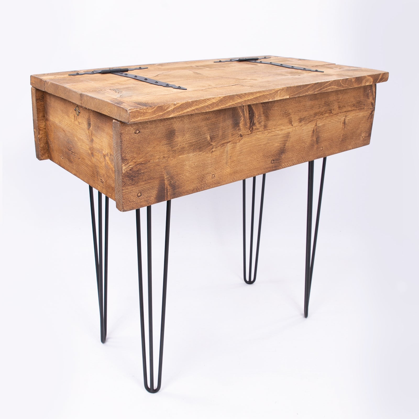 Rustic wooden blanket box with black metal hairpin legs and hinged lid secured by dark iron straps for storage