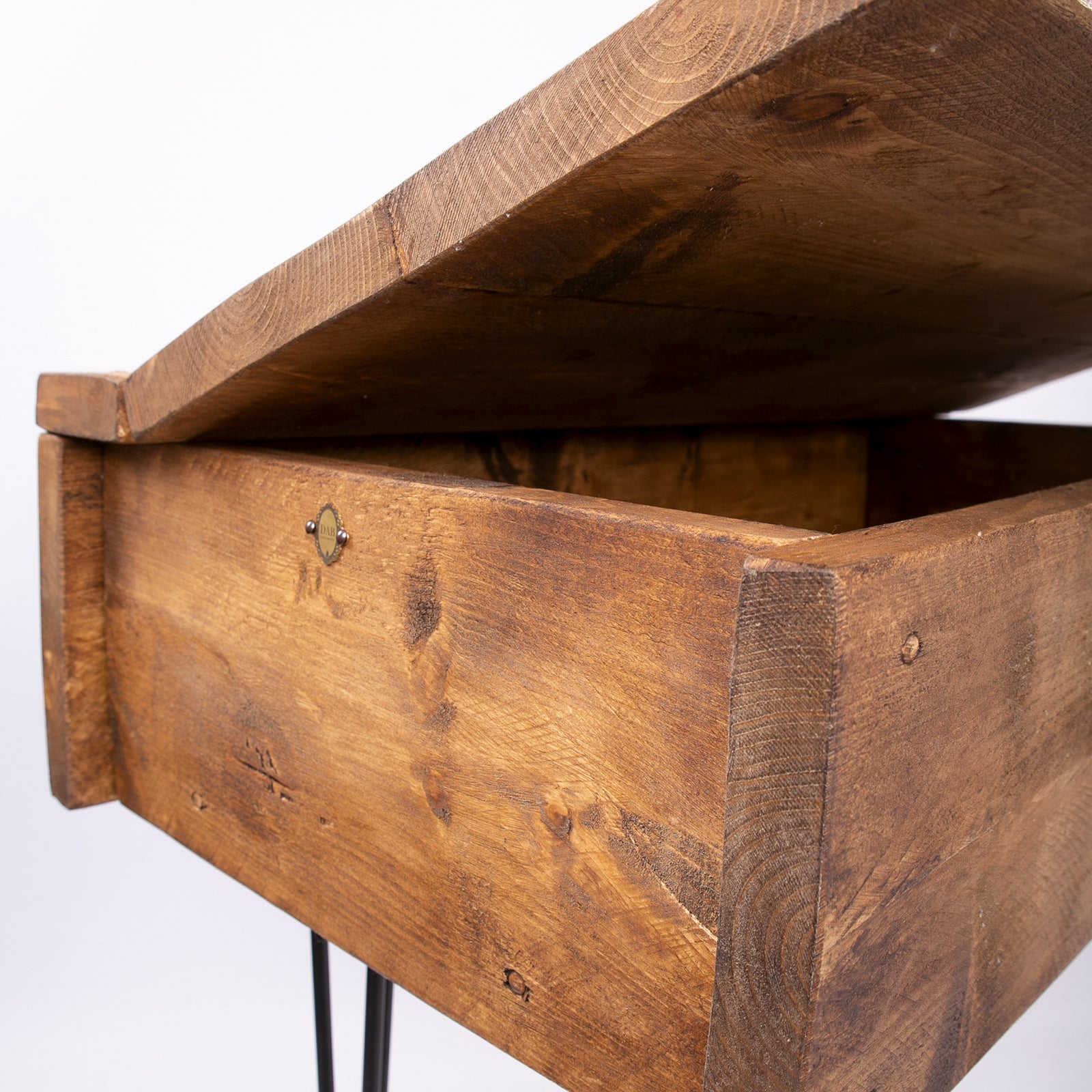 Rustic wooden blanket box with visible grain natural wood finish and black metal legs as a hairpin storage chest