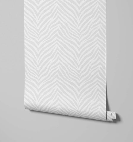 A sleek modern print wallpaper roll featuring bold white and gray zebra print in a chevron design called hakambo