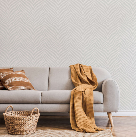 Light gray hakambo sofa with wooden legs and mustard yellow throw, perfect for zebra print wallpaper rooms