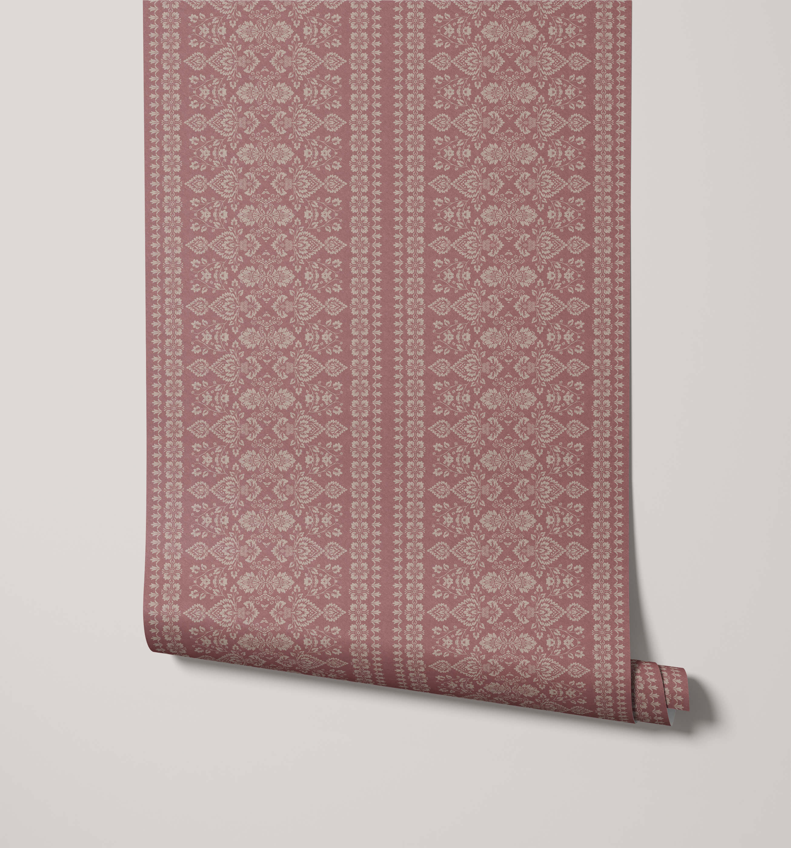 A roll of hallen dusty rose damask floral wallpaper with an intricate off-white repeating pattern