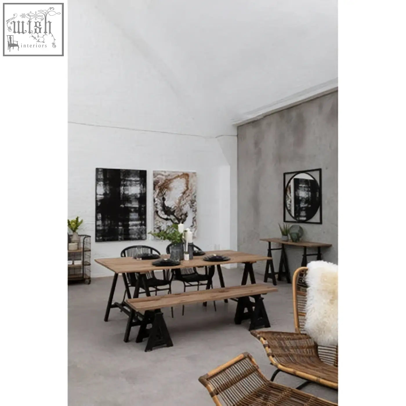 Minimalist dining area with a long pine wood console table featuring an iron base and black metal chairs and benches