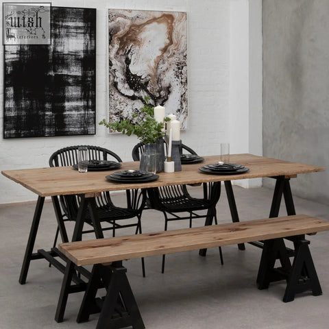Rustic pine wood console table with black iron base and matching bench featuring trestle legs for dining use