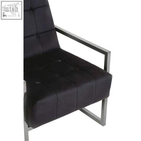 Black velvet chair with tufted leather and a sleek stainless steel frame perfect for stylish seating