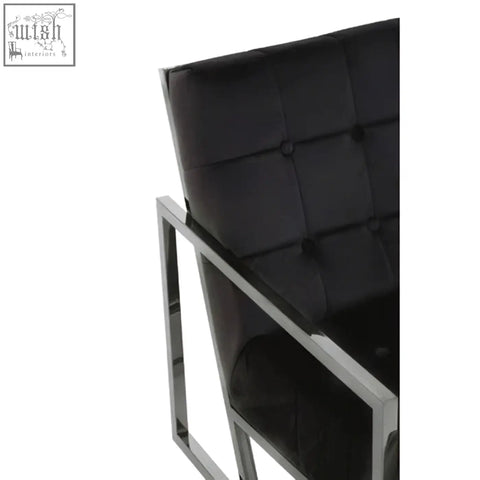 Black tufted velvet chair with sleek stainless steel frame perfect for modern living spaces
