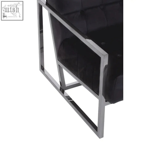 Black tufted velvet chair with a sleek chrome stainless steel frame perfect for stylish modern seating