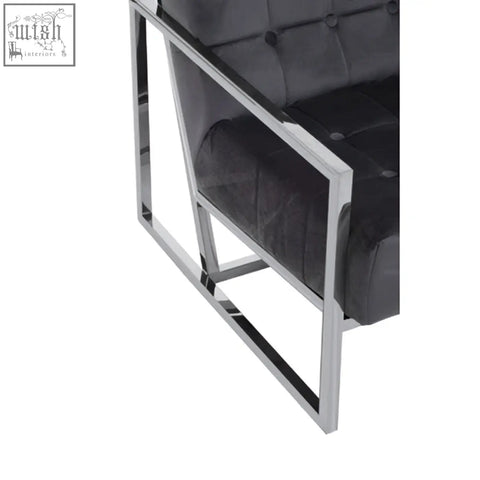Black tufted leather armchair with a sleek stainless steel frame perfect for stylish modern seating