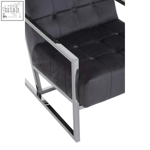 Black tufted leather armchair with a sleek stainless steel frame and steel frame for modern stylish seating
