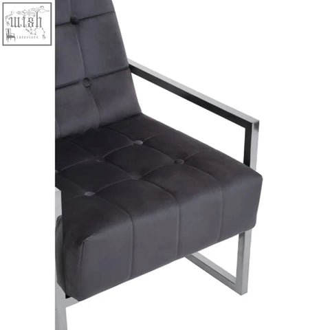 Black tufted leather armchair with a sleek stainless steel frame perfect for modern living spaces