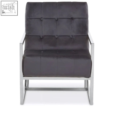 Dark gray tufted velvet armchair with sleek stainless steel frame perfect for modern living spaces