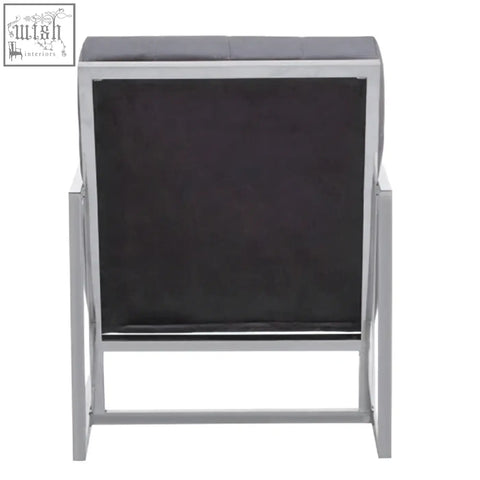 Modern hana grey velvet chair with sleek black upholstery and a shiny stainless steel frame for stylish seating