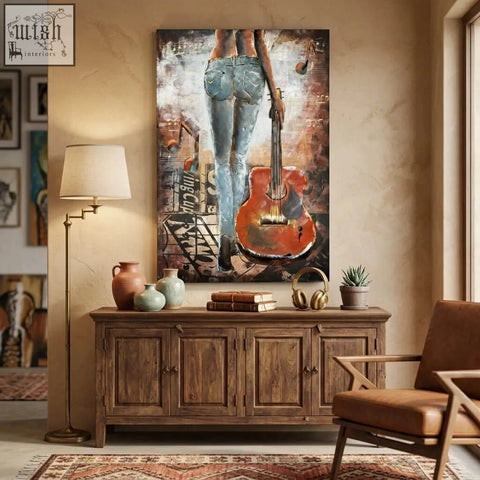 Back view of handcrafted woman with guitar 3d metal wall art featuring blue jeans and orange guitar for living room wall decor