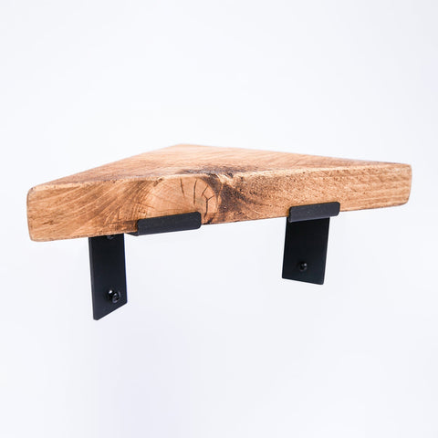 Handmade bespoke corner shelf with rustic wooden finish and black steel brackets for sturdy wall mounting