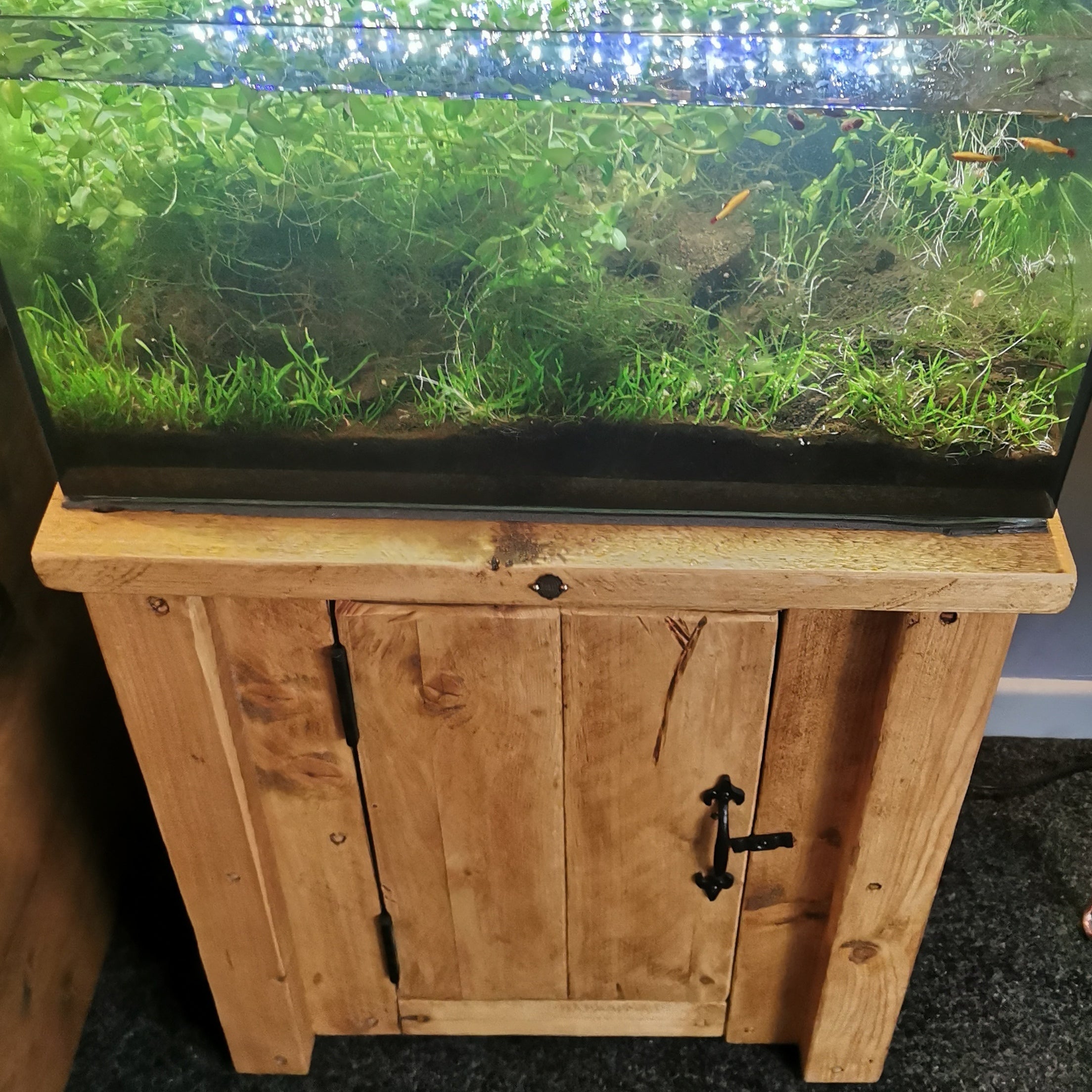 Handmade fish tank and aquarium stand with rustic natural wood finish and black metal hinges for custom sizes and colours